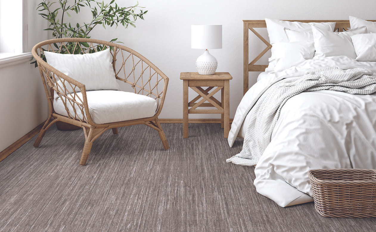 Berber beige carpet in a coastal inspired wicker bedroom. 